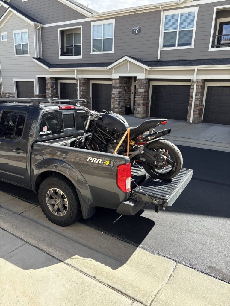 Ducati Monster 696 strapped into the bed of a pickup truck