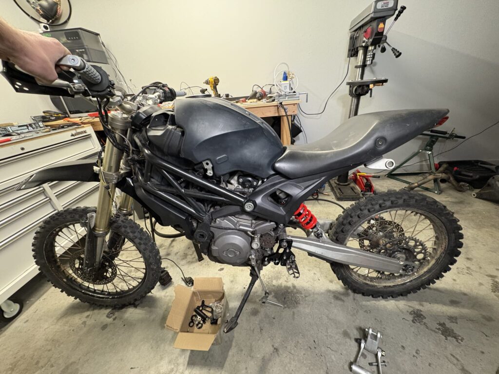 The bike standing on both wheels for the first time, still with the Ducati tank and seat