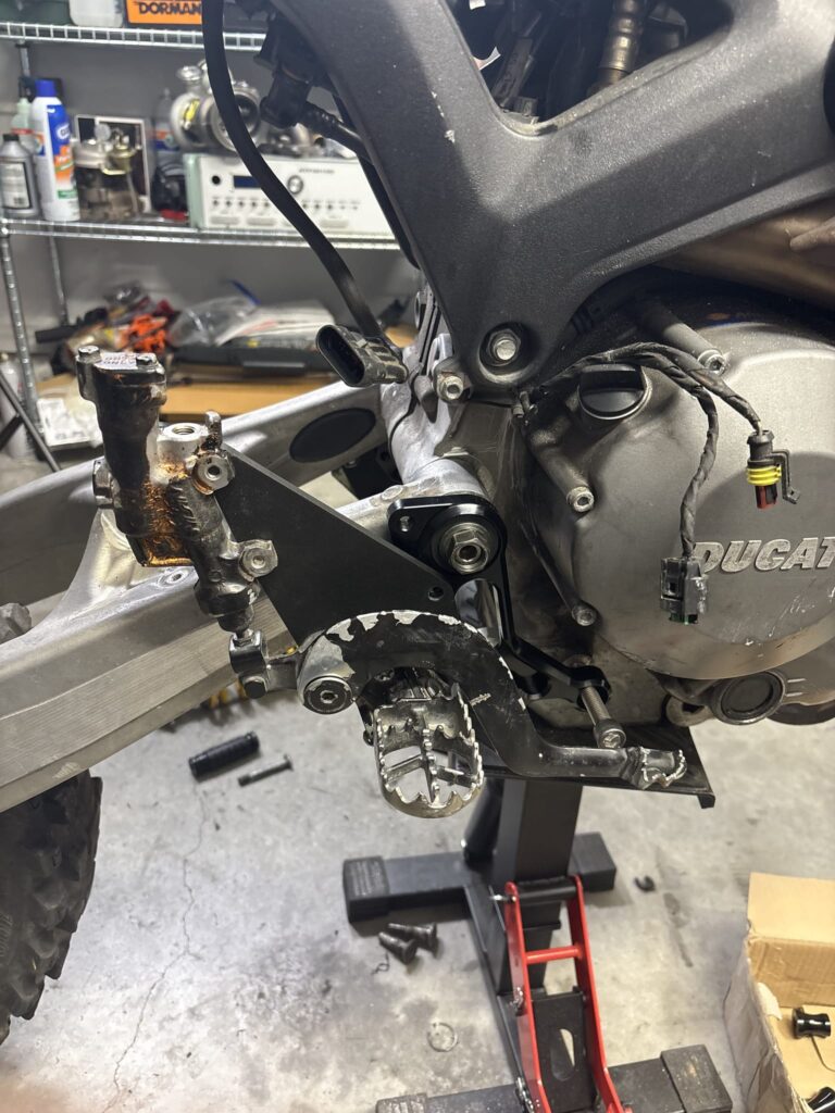 3D printed footpeg adapter plate test fitted with a YZ450F footpeg