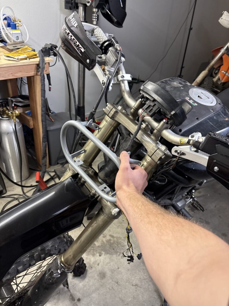 Test fitting a tubular headlight bracket on the forks
