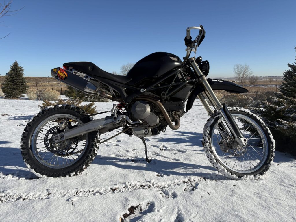 The bike in the snow with the Ducati tank and seat