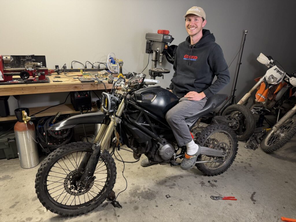 Lucas sitting on the bike in his garage