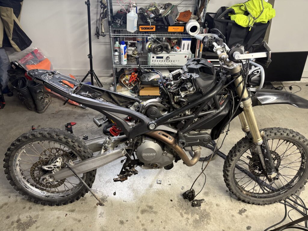 The bike stripped of its tank, airbox and seat, showing the Ducati trellis frame