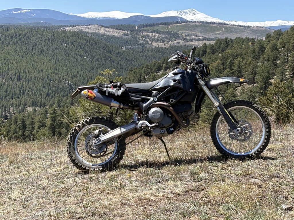 The finished DirtCati on a hilltop with snowy mountains behind