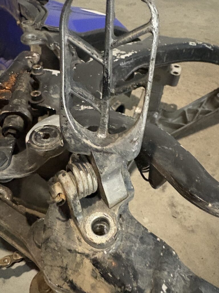 Footpeg and bracket on the YZ450F frame
