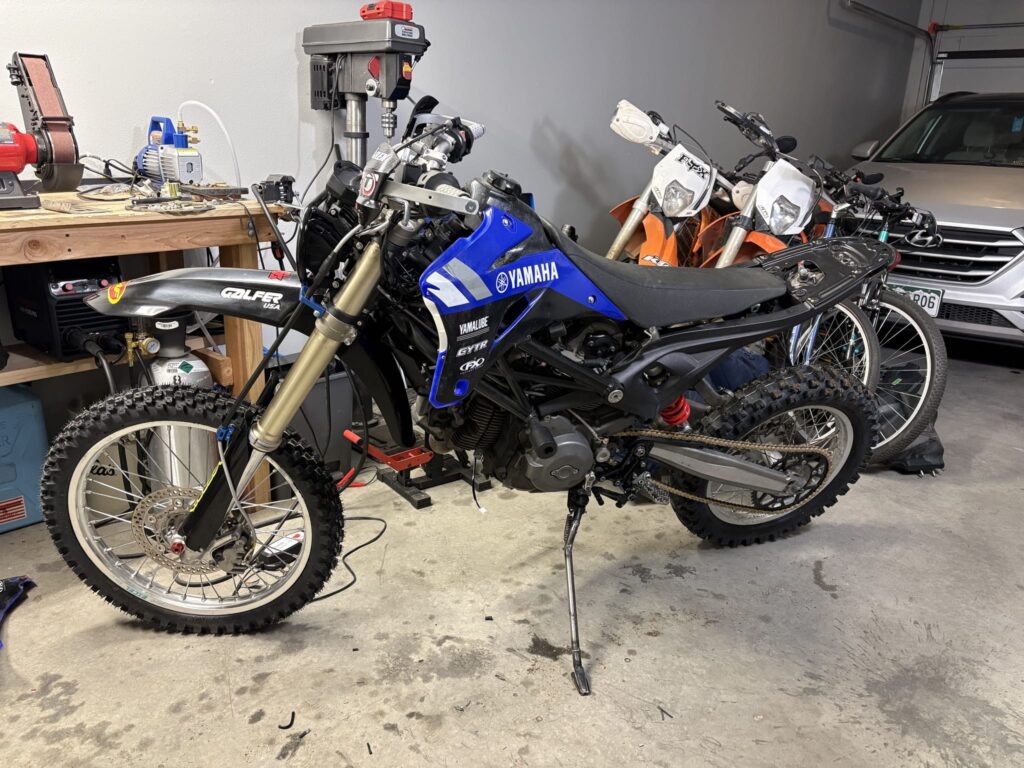 The bike with the YZ450F tank and blue Yamaha plastics